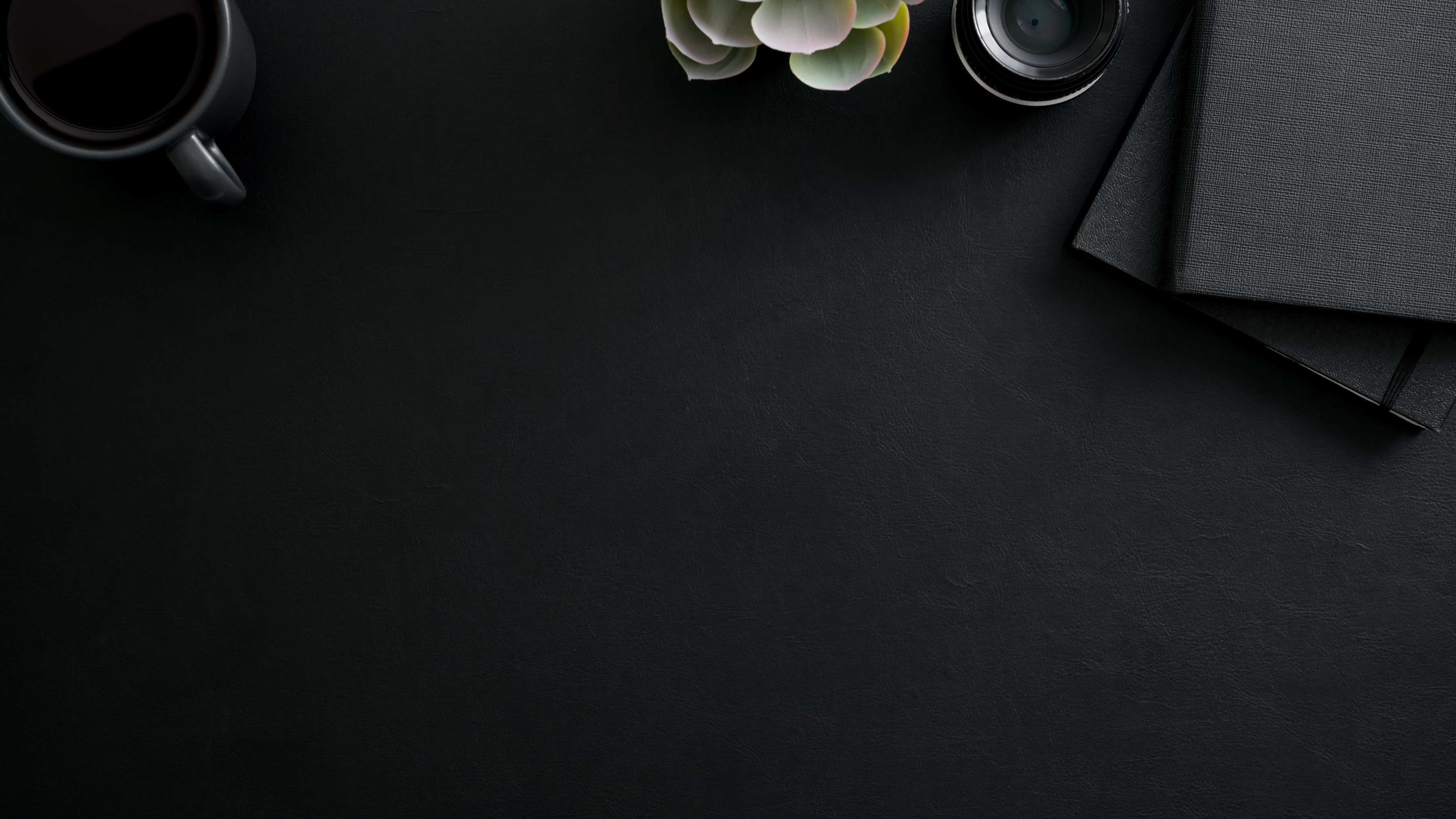 Black Coffee Cup and Black Notepad on Black Table